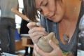 A student works on her ceramic creation during the annual Otterbein...