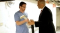 Mayor Cory Booker hands a guitar to Greg Townsend '05 in a scene from...