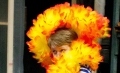 Chloe Luetkemeyer '13 peeks through a feather boa in rehearsal for...