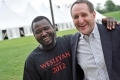 Kennedy Odede '12 shares a hug with Dave Bartholomew '81 P'14 outside...