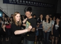 Crystal Miller '12 is joined in a traditional polka dance by a student...