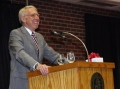 Chemistry professor Alan Goren talks to a crowd of faculty and staff...