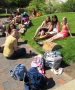 Students "pre-tan" while waiting for a ride to Lake Michigan this...