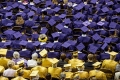 A sea of purple and gold graduates.