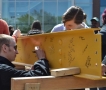 Students signing a steel support beam, which will be installed in...